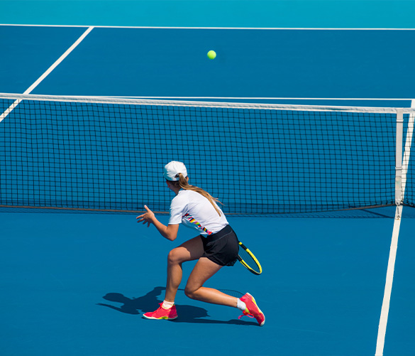 Junior players competing in a tennis match play session